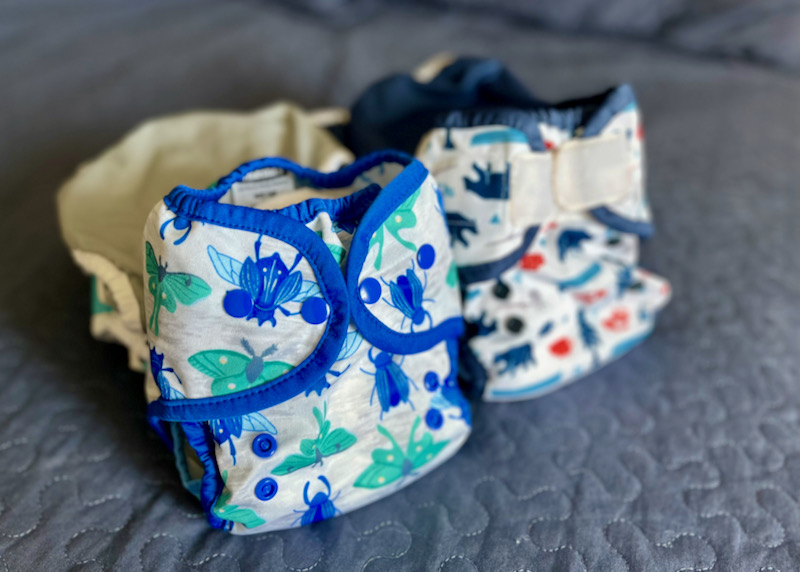 Cloth diapers with fun prints displayed on blue background